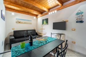 a living room with a table and a couch at Casa Ornella in Nebida