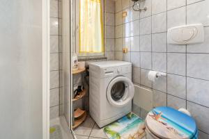 a small bathroom with a washing machine in it at Casa Ornella in Nebida +8 photos