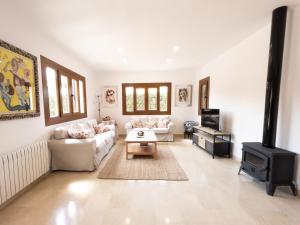 a living room with a couch and a stove at Villa Isabel in Campos