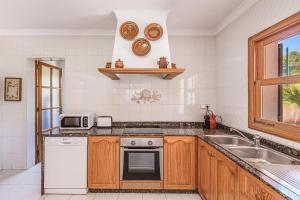 a kitchen with a sink and a stove at Villa Isabel in Campos