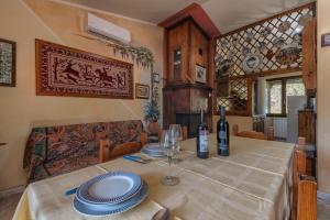 a dining room with a table with plates and wine bottles at Casa Lilliu in Villacidro +15 photos