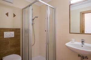 a bathroom with a shower and a toilet and a sink at Wollbach - Gruberhof in San Giacomo +16 photos
