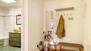 a bathroom with a sink and a towel hanging on the wall at Ferienwohnung Arenda in Munzingen +13 photos
