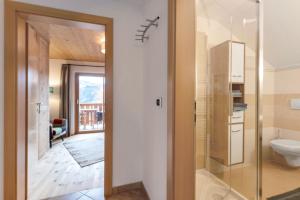 a bathroom with a toilet and a glass door at Ferienwohnung Thymian Thalerhof in Ponte Nova +22 photos