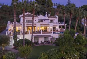 an aerial view of a house with palm trees at Villa Sildavia in Estepona