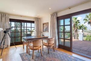 a home office with a desk and a large window at Villa Sildavia in Estepona