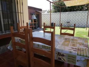 a dining room with a table and chairs and a fireplace at Chalet Tu Limonero in Chiclana de la Frontera