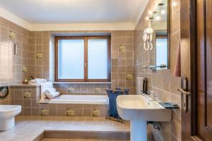 a bathroom with a tub and a sink at The Lodge Monte Bondone in Vason +27 photos