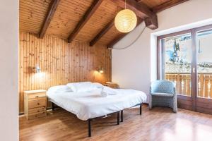 a bed in a room with a wooden wall at The Lodge Monte Bondone in Vason