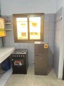 a small kitchen with a stove and a window at Deckon in Avéméné