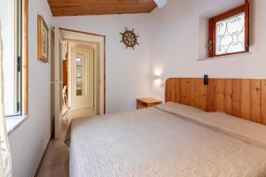 a bedroom with a bed and a window at La Casetta Della Rocca Cefalù in Cefalù