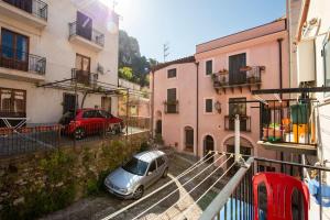 a car parked in a parking lot between buildings at La Casetta Della Rocca Cefalù in Cefalù
