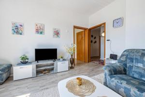 a living room with a couch and a tv at Haus Elseaue in Bünde