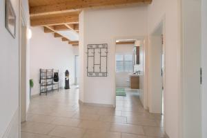an open hallway with white walls and a tile floor at Ferienwohnung Panoramablick in Leipheim +21 photos