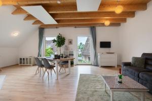 a living room with a couch and a table at Ferienwohnung Panoramablick in Leipheim