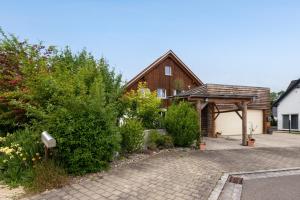 a house with a pavilion and a brick driveway at Ferienwohnung Panoramablick in Leipheim
