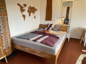a bed in a room with a map on the wall at Apartment Lüneburger Heide in Hankensbüttel