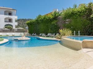 a swimming pool in the middle of a resort at Sa Torre iii in Canyamel