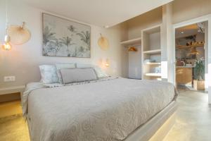 a bedroom with a large white bed with blue pillows at Oceania Villa Private Pool Garden in Chayofa +31 photos