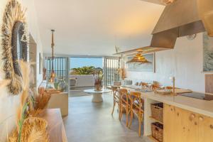 a kitchen with a island with chairs and a table at Oceania Villa Private Pool Garden in Chayofa
