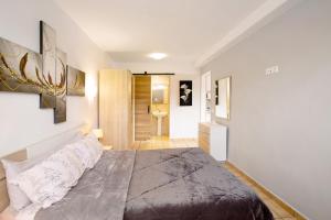 a bedroom with a large bed and a bathroom at Montemar 1 in Moya +12 photos