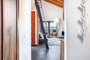 a hallway with a staircase in a house at Ferienhaus Sonnenwind Hainer See Og in Neukieritzsch