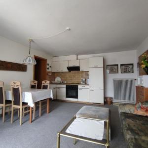 a kitchen and dining room with a table and chairs at Haus Maria Bodensdorf in Tratten