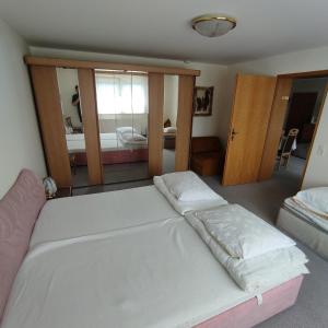 a bedroom with a bed and a large mirror at Haus Maria Bodensdorf in Tratten