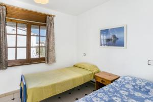 a bedroom with two beds and a window at Villa La Flor con piscina in L'Escala +24 photos