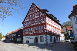 a tall red and white building on a street at Fewo Heym in Suhl