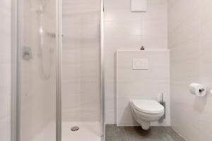 a white bathroom with a toilet and a shower at Forchnerhof Apt Ploseblick in Maranza +23 photos