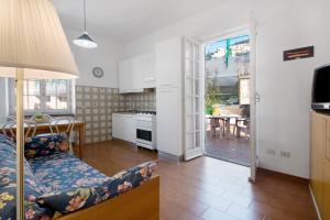 a kitchen and living room with a couch and a table at Via Colombo 12 Bilo in Bonassola