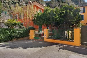 an orange building with a gate in front of it at Via Colombo 12 Bilo in Bonassola