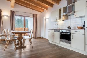 a kitchen and dining room with a table and chairs at Sabina Dolomites Birke in Alpe di Siusi