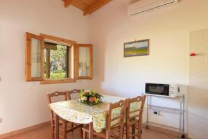 a dining room table with a flower arrangement on it at Agriturismo Alimini a Otranto in Alimini