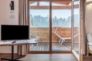 an office with a desk and a computer on a balcony at Sabina Dolomites Birke in Alpe di Siusi