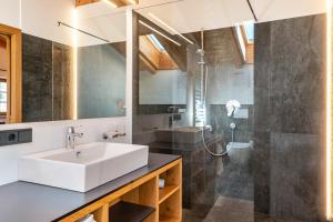 a bathroom with a sink and a shower at Schreiberhof Charme in Laion +20 photos