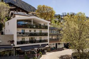 an apartment building with balconies and a courtyard at Schenna Chalet - Apt Stefan in Schenna