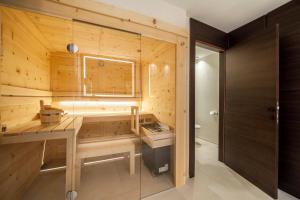 a bathroom with a sauna with a wooden wall at Schenna Chalet - Apt Stefan in Schenna +17 photos
