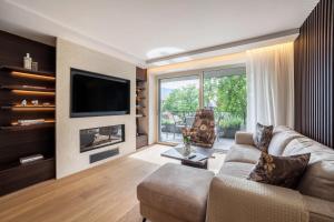 a living room with a couch and a fireplace at Schenna Chalet - Apt Stefan in Schenna
