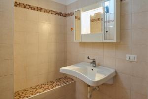 a bathroom with a sink and a mirror at Antichi Palmenti - Alloro in San Vincenzo +18 photos