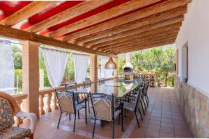 a dining room with a table and chairs at Villa Juana Maria in Cala Murada