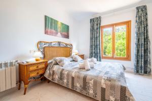 a bedroom with a bed and a window at Villa Juana Maria in Cala Murada +23 photos