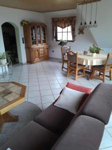 a living room with a couch and a table at Ferienwohnung Heinz Romes in Wimbach