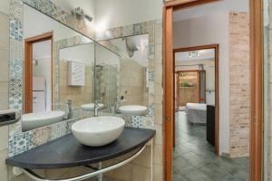 a bathroom with three sinks and a large mirror at Buggerru Hugo House in Buggerru +17 photos