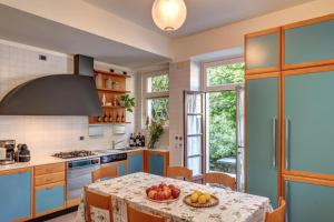 a kitchen with a table with a bowl of fruit on it at Villa Il Cigno Lakeside in Oliveto Lario