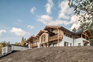 a house on top of a pile of dirt at Les Ciases Chalets Dolomites Apt 6 in San Vigilio Di Marebbe