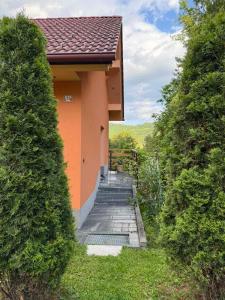 a small building with a stairway leading to a porch at Hideaway Kos in Loka pri Žusmu