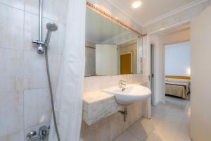 a bathroom with a sink and a shower with a mirror at Apartament Massanet ba in Canyamel +17 photos