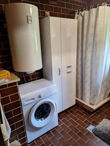 a white washer and dryer in a kitchen at Hideaway Kos in Loka pri Žusmu